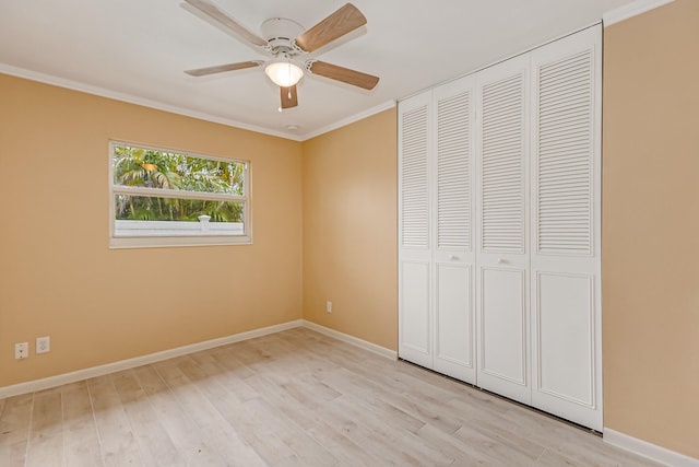 unfurnished bedroom featuring ornamental molding, ceiling fan, light hardwood / wood-style floors, and a closet