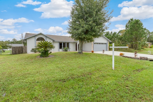 ranch-style home with a garage and a front lawn