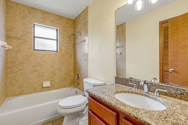 full bathroom with toilet, vanity, and tiled shower / bath