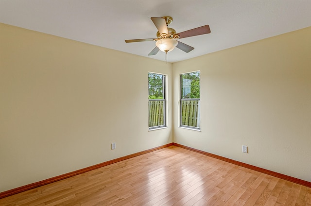 empty room with wood-type flooring and ceiling fan