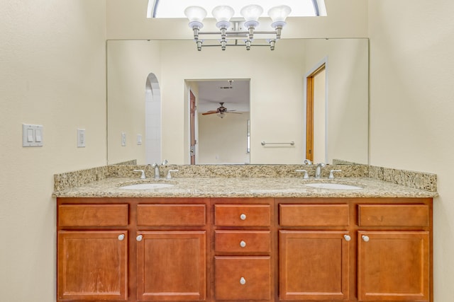 bathroom featuring ceiling fan and dual bowl vanity