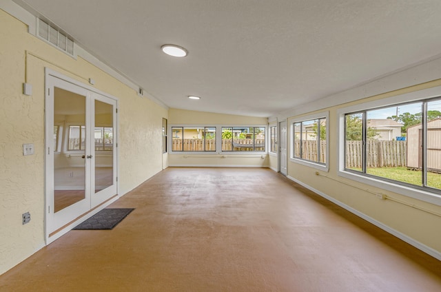 unfurnished sunroom with lofted ceiling and french doors