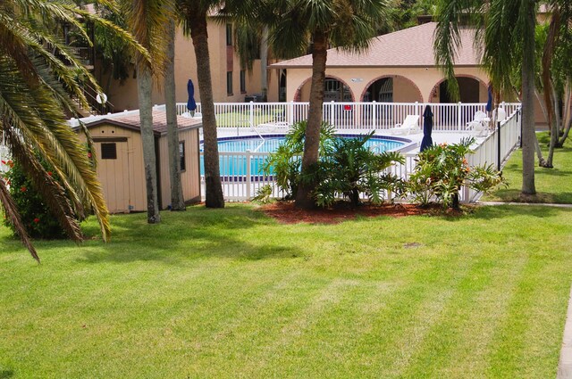 view of swimming pool with a yard