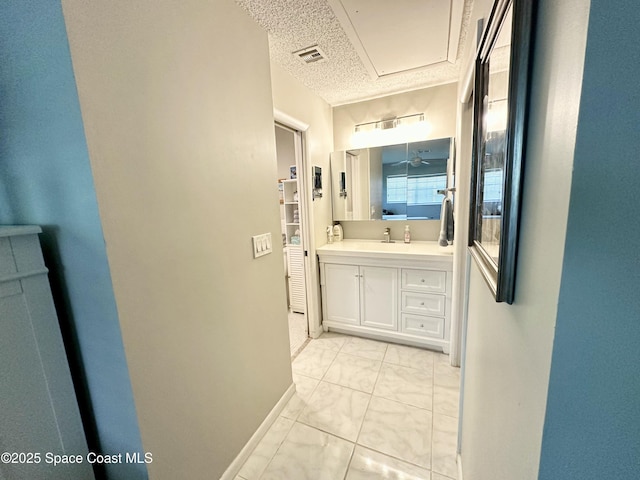 bathroom with vanity and a textured ceiling