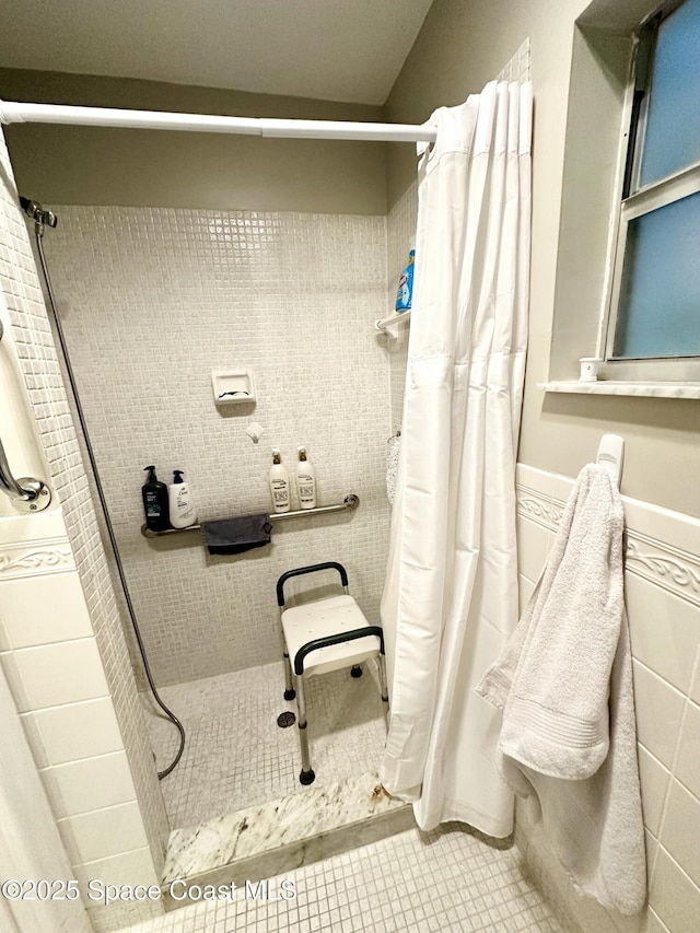 bathroom with tile patterned floors and a shower with shower curtain