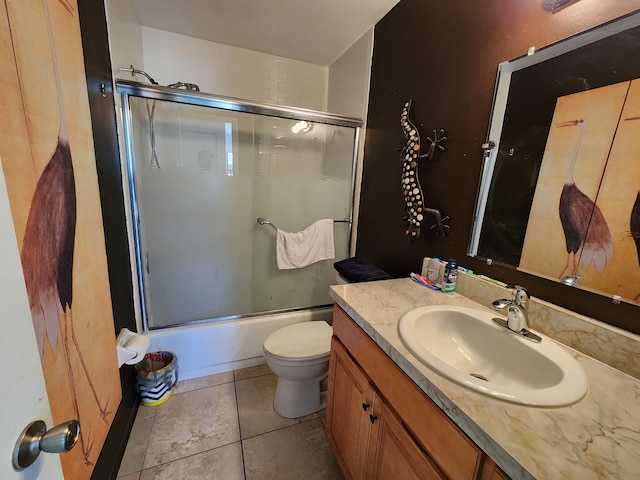 full bathroom with tile patterned floors, vanity, toilet, and combined bath / shower with glass door