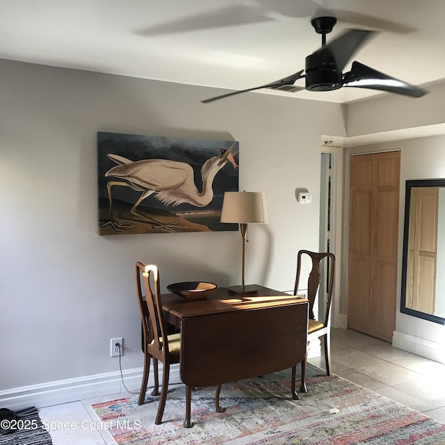 dining space featuring light tile patterned floors and ceiling fan