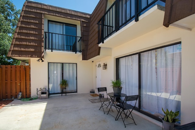 back of house featuring a patio area and a balcony