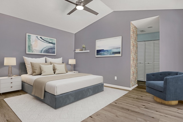 bedroom featuring hardwood / wood-style flooring, vaulted ceiling, ceiling fan, and a closet