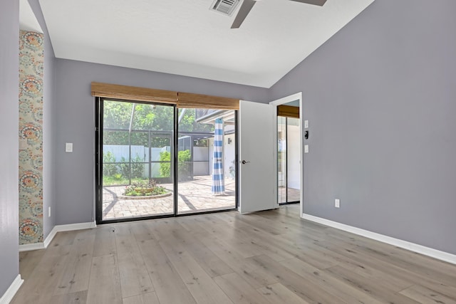 spare room featuring ceiling fan, lofted ceiling, and light hardwood / wood-style floors