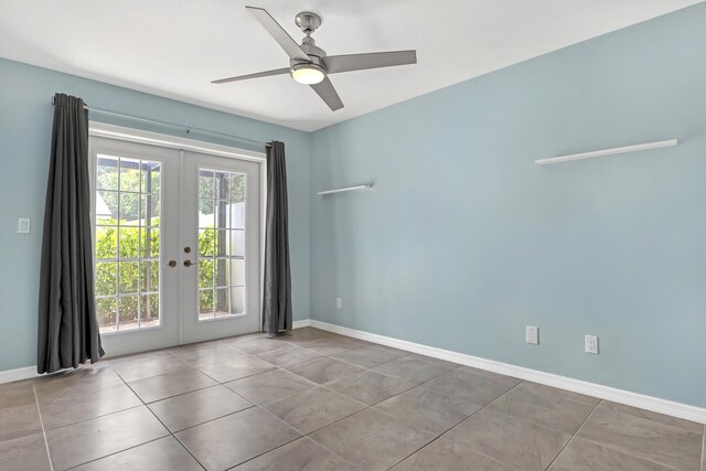 tiled spare room with a wealth of natural light, ceiling fan, and french doors