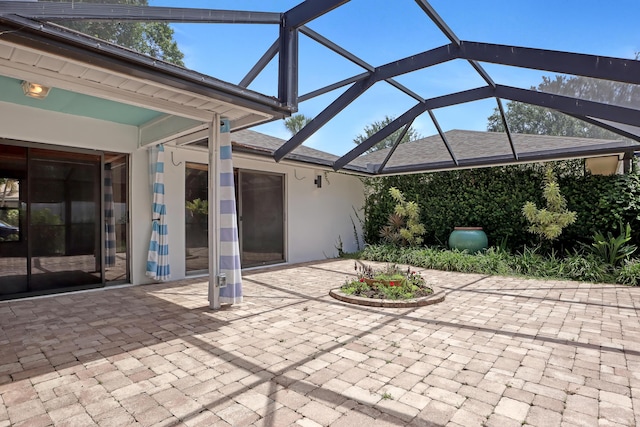 view of patio featuring a lanai