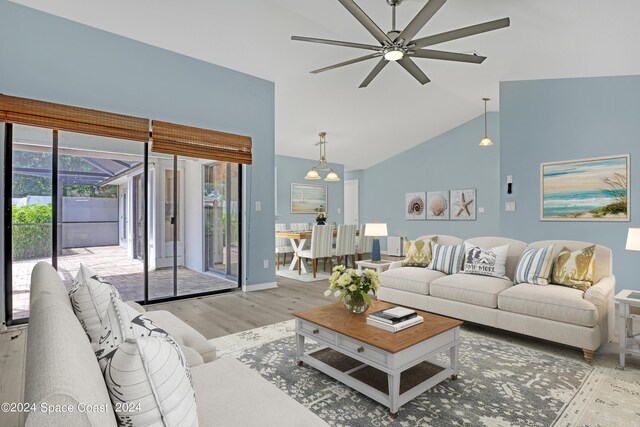 living room with ceiling fan, lofted ceiling, and light hardwood / wood-style flooring