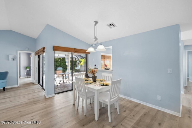 6209 S Mirror Lake Dr Unit 7, Sebastian, FL 32958 - dining room with lofted ceiling, light wood-type flooring, and baseboards