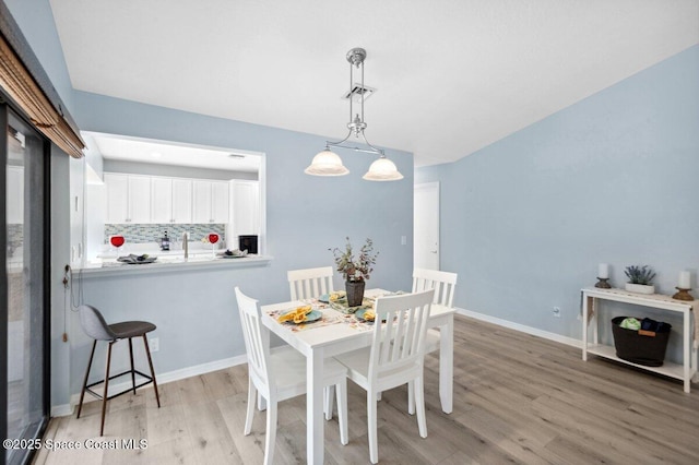 6209 S Mirror Lake Dr Unit 7, Sebastian, FL 32958 - dining space with light wood-type flooring and baseboards