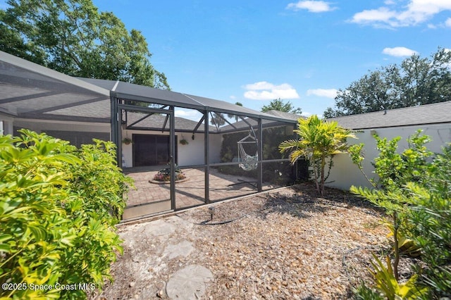 6209 S Mirror Lake Dr Unit 7, Sebastian, FL 32958 - rear view of house with glass enclosure and a patio area