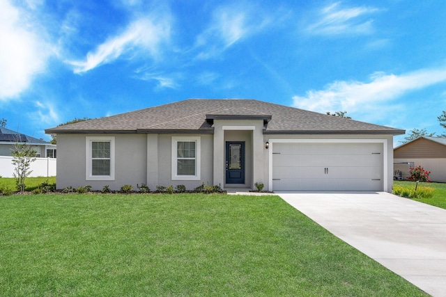 view of front facade with a front yard and a garage