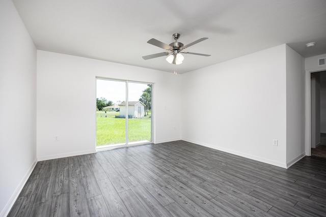 spare room featuring ceiling fan and dark hardwood / wood-style flooring