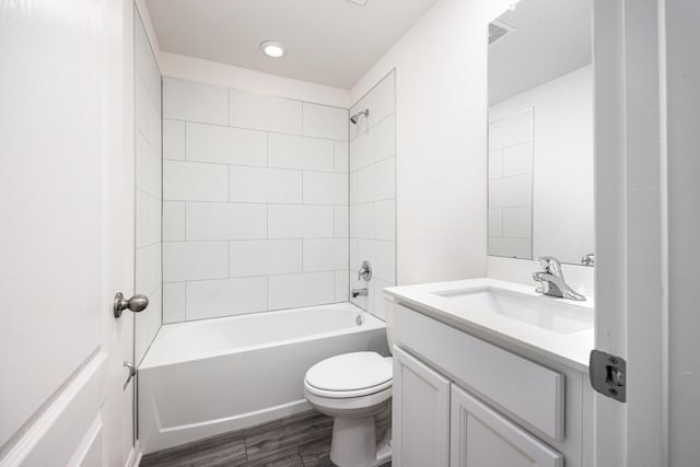 full bathroom with hardwood / wood-style flooring, vanity, toilet, and tiled shower / bath combo