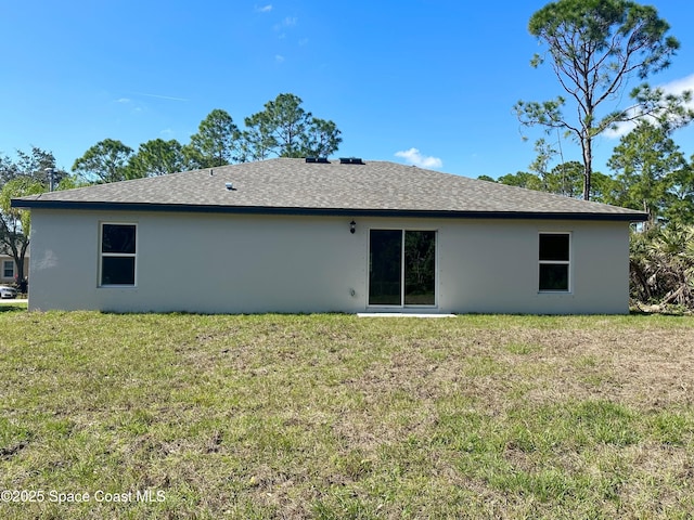 back of property featuring a lawn