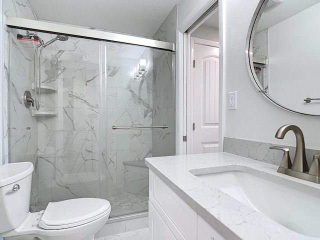 full bath featuring toilet, marble finish floor, a marble finish shower, and vanity