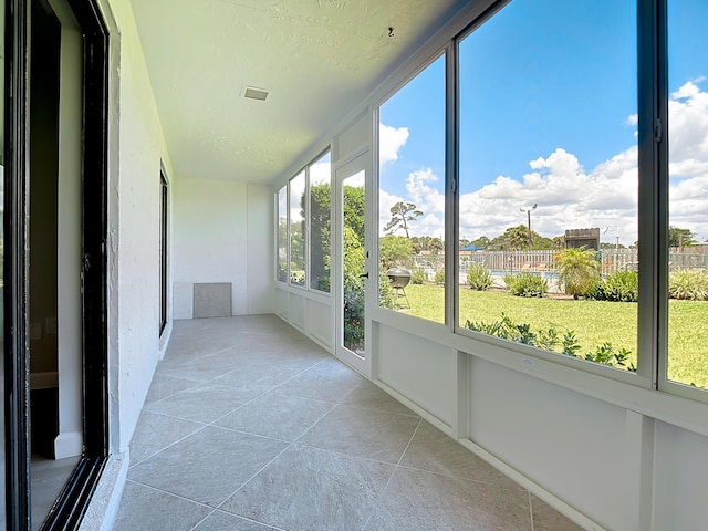 unfurnished sunroom with visible vents