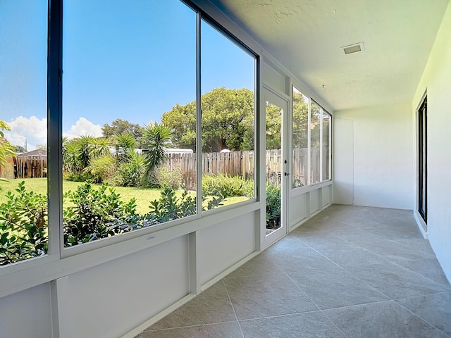 unfurnished sunroom with visible vents