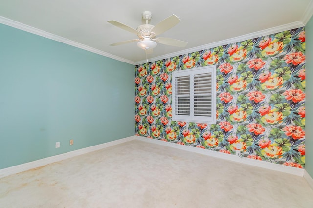 carpeted spare room featuring wallpapered walls, crown molding, baseboards, and ceiling fan