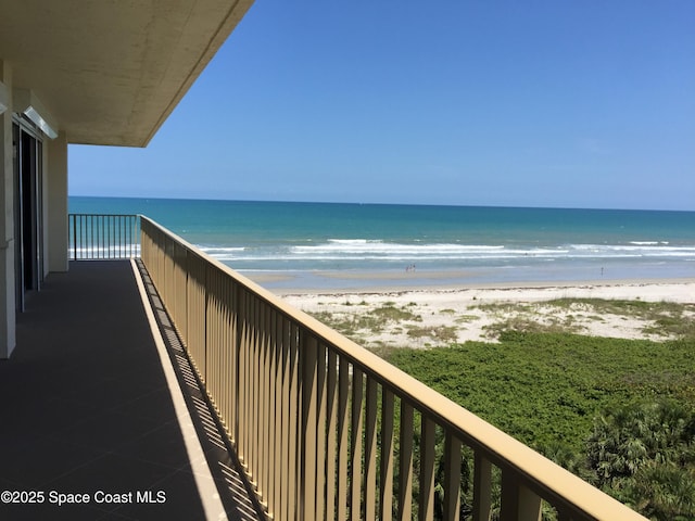 balcony with a beach view and a water view