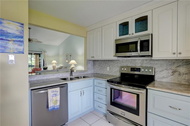 9635 Riverside Dr Unit 3, Sebastian, FL 32958 - kitchen with light tile patterned flooring, sink, white cabinets, backsplash, and stainless steel appliances
