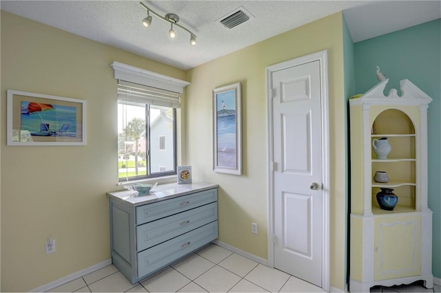 9635 Riverside Dr Unit 3, Sebastian, FL 32958 - tiled bedroom featuring track lighting and a textured ceiling