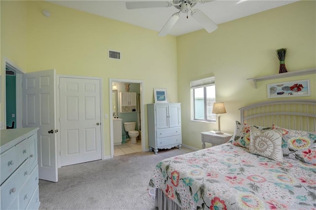 9635 Riverside Dr Unit 3, Sebastian, FL 32958 - bedroom with ceiling fan, ensuite bathroom, high vaulted ceiling, and light carpet