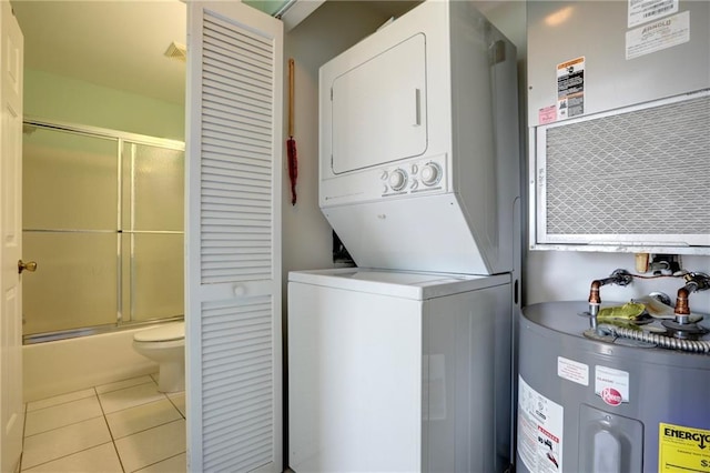 9635 Riverside Dr Unit 3, Sebastian, FL 32958 - laundry room featuring light tile patterned floors, water heater, and stacked washer / dryer