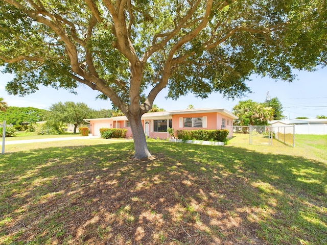 ranch-style home featuring a front yard and a garage