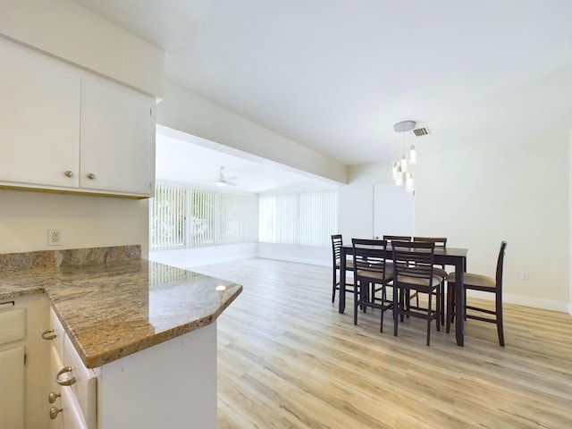 dining space featuring ceiling fan and light hardwood / wood-style floors