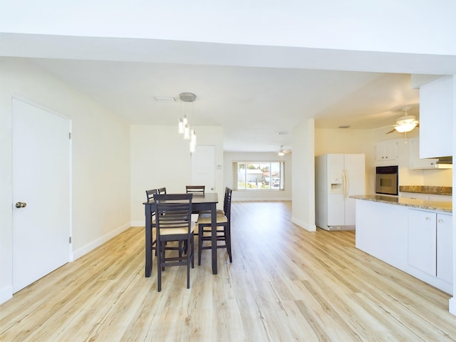 dining space featuring ceiling fan and light hardwood / wood-style flooring