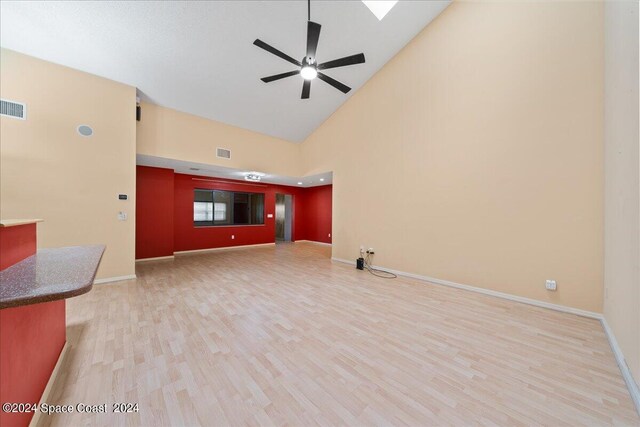 unfurnished living room featuring ceiling fan, high vaulted ceiling, and hardwood / wood-style flooring