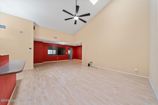 unfurnished living room with light wood-style floors, a ceiling fan, visible vents, and baseboards