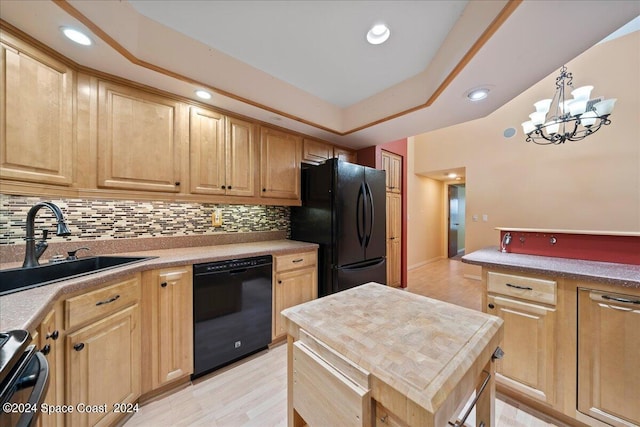 kitchen with light brown cabinetry, sink, black appliances, pendant lighting, and a chandelier