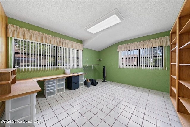 tiled office with vaulted ceiling and a textured ceiling