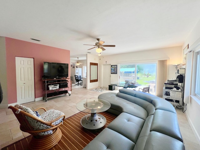 tiled living room featuring ceiling fan