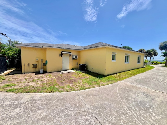 back of house with central AC