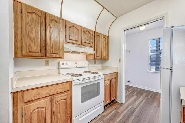 kitchen with hardwood / wood-style flooring and white appliances