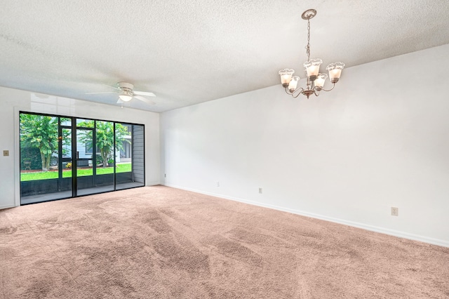 carpeted empty room featuring ceiling fan with notable chandelier and a textured ceiling