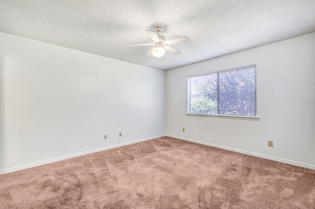 carpeted spare room with a textured ceiling and ceiling fan