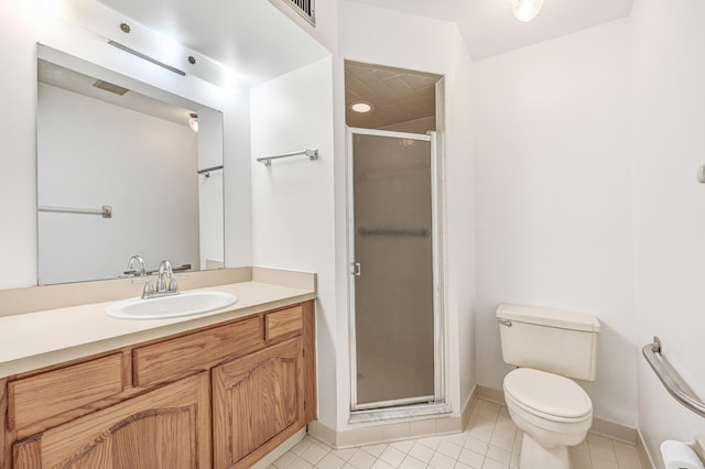 bathroom with a shower with door, vanity, tile patterned flooring, and toilet