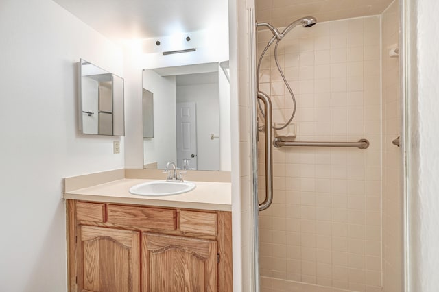 bathroom with vanity and a tile shower