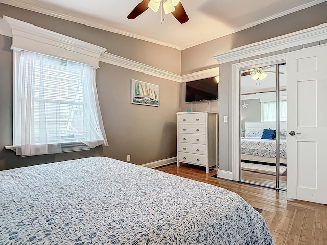 bedroom featuring crown molding, a closet, ceiling fan, and hardwood / wood-style flooring