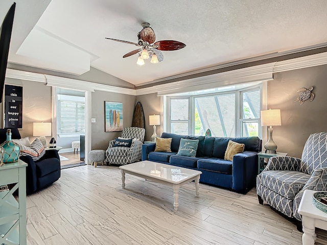 living room with lofted ceiling, hardwood / wood-style flooring, crown molding, and a textured ceiling