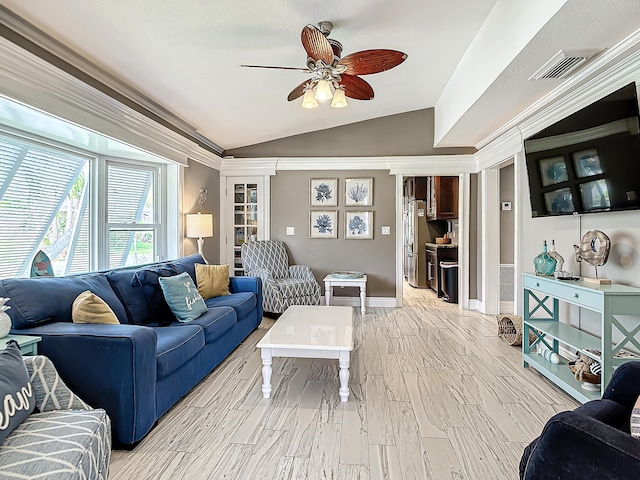 living room with crown molding, ceiling fan, light hardwood / wood-style floors, and vaulted ceiling